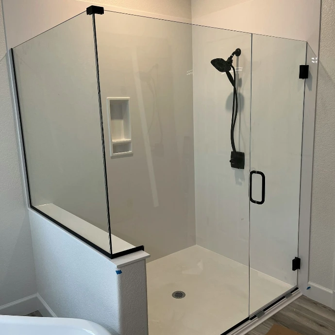 a bathroom with a glass shower door and a tub